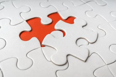 One last piece of white empty puzzle is missing. Stock Photos