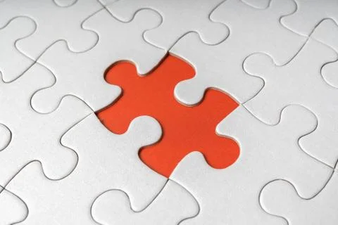 One last piece of white empty puzzle is missing. Stock Photos