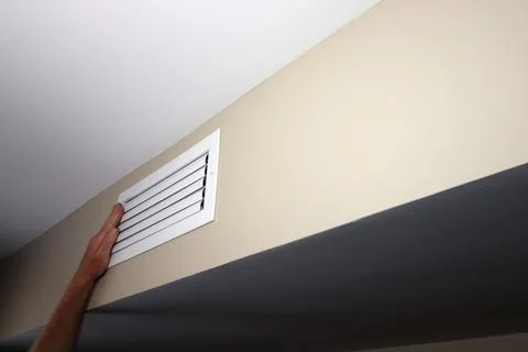One Left Hand on a Closed White Rectangle Wall Air Duct Vent Stock Photos