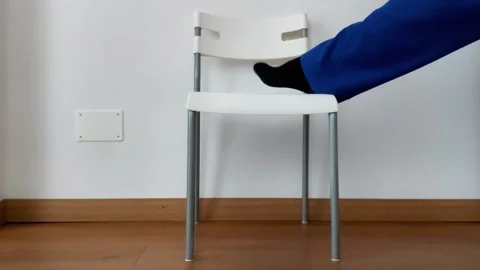 One Leg Stretch Using Chair, Blue Pants and Black Socks Framing Stock Footage 323432582