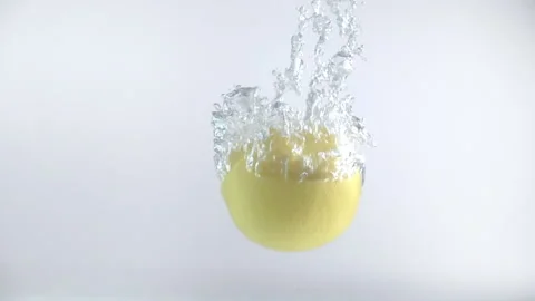 One lemon fall into the water with splashes and bubbles in slow motion. Stock Footage 144454788