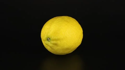 One lemon rotates on a black background. Close-up video vitamin C. 스톡 동영상 151995823