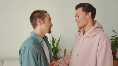 One of the lgbt men is stroking another one's body, they are talking and smiling Stock Footage 173813015