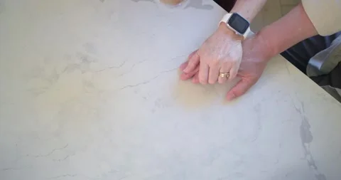 One is lifting mug above hands on countertop, other is adjusting, third is Stock Footage 337933160