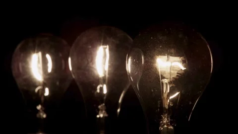 One light bulb flickers then glows in the dark Stock Footage 329666872