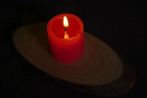 One light candle burning brightly in the black background Stock Photos