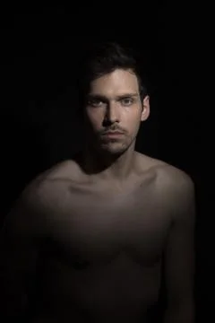 One light dim portrait of one young man. Foto stock