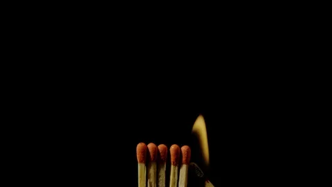 One lit match spreading fire to other matches, Ultra Slow Motion Stock Footage 86576079