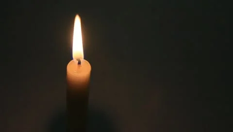 One lit white candle on black Stock Footage 11022369