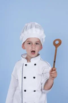 One little boy as chef cook making salad, cooking with vegetables. Stock Photos