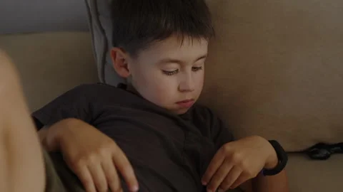 One little boy lying on sofa resting pensive. Beautiful family. People lifestyle Stock Footage 249960167