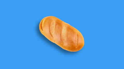 One loaf of bread approaching on blue background Stock Footage 101254755