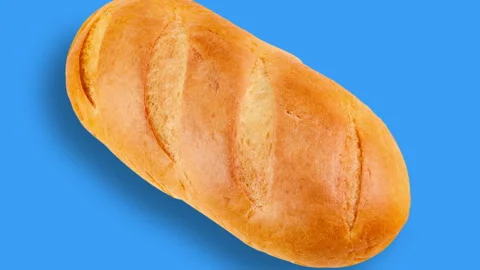 One loaf of bread moving away on blue background Stock Footage 101234775
