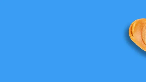 One loaf of bread slide in center and approaching on blue background Stock Footage 101257568