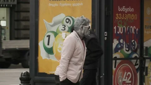 One made-up man with a gray face and hands is standing on the street Stock Footage 220738022