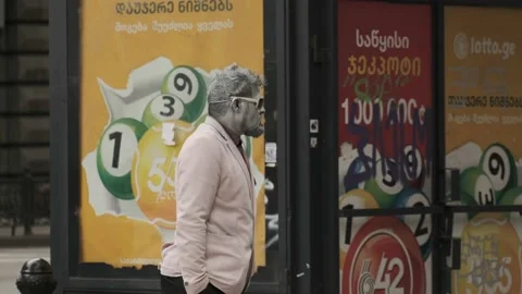 One made-up man with a gray face and hands is standing on the street Stock Footage 220738318