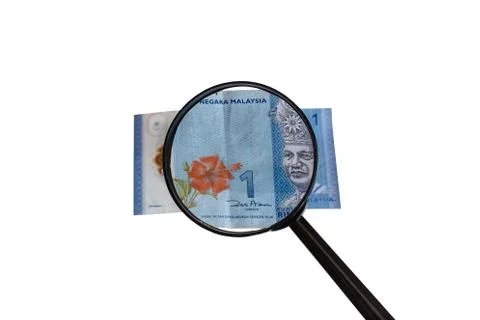 One Malaysia Ringgit bill and magnifying glass Stock Photos