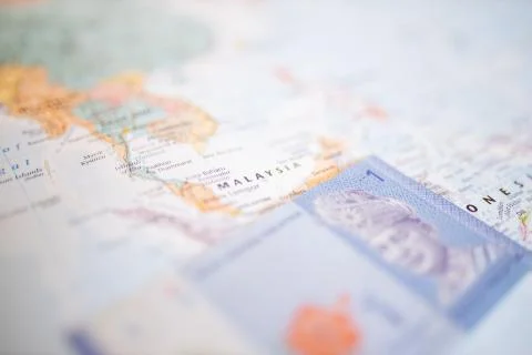 One Malaysian ringgit bill under Malaysia on a colorful and blurry Asia map Stock Photos