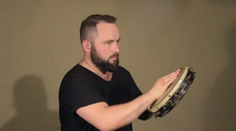 One Man With a Beard in Black T-Shirt, Playing on the Percussion Instrument Stock Footage 67106683