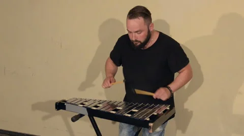 One Man With a Beard in Black T-Shirt, Playing on the Percussion Instrument Stock Footage 68178521