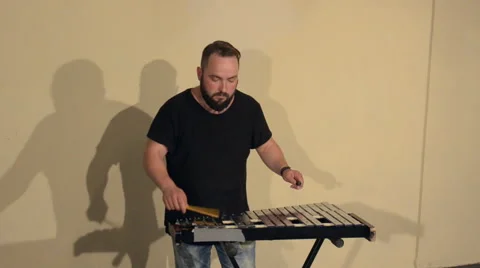 One Man With a Beard in Black T-Shirt, Playing on the Percussion Instrument Stock Footage 68178592