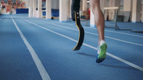 One man with bionic leg training on a running track, back view. Stock Footage 100832423