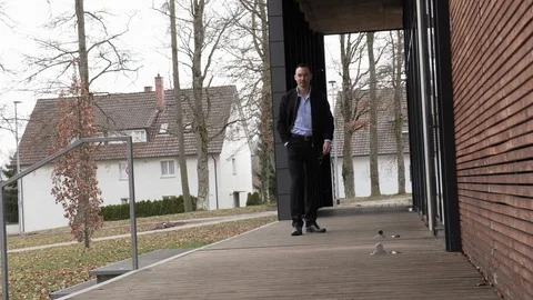 One man in a black jacket and sunglasses on the street Stock Footage 126554323