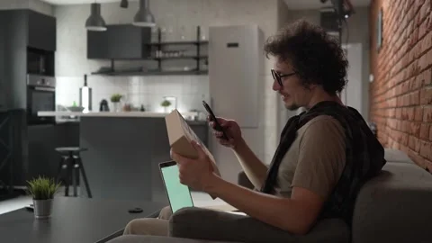One man checking box of received package or product at home Stock Footage 249462815