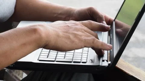 One man Checking the notebook problem is open Machine does not work. Stock Photos