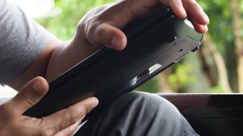 One man Checking the notebook problem is open Machine does not work. Stock Photos