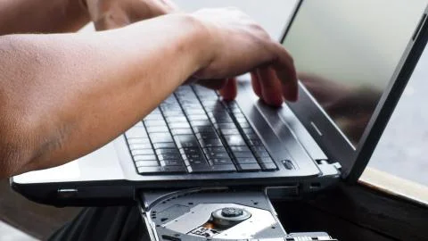 One man Checking the notebook problem is open Machine does not work. Stock Photos