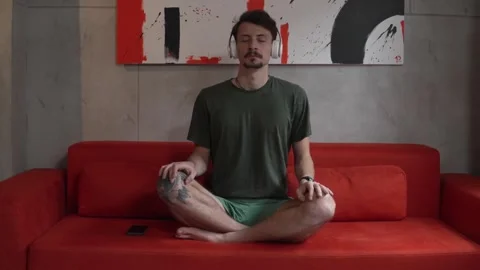 One man doing guided meditation yoga self care practice at home Stock-Footage 242770549