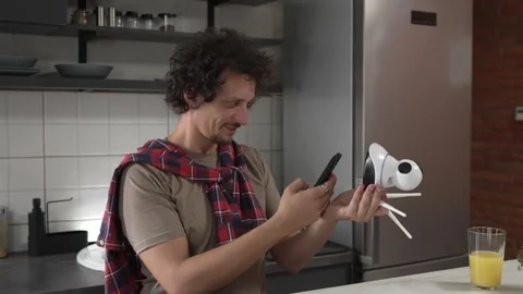 One man install setup home security surveillance camera on smartphone Stock Footage 249400963