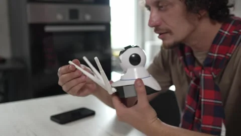 One man install setup home security surveillance camera on smartphone Video stock 249401039