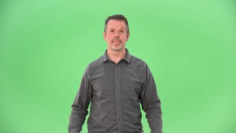 One man looking at the camera and shrugging on green screen 動画素材 100103115