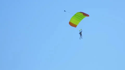 One man parachuting performing controlled descent Stock Footage 244913428