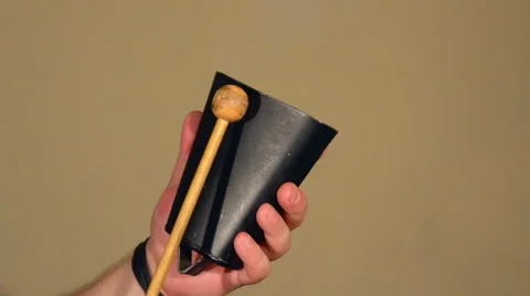 One Man Playing on the Percussion Instrument Cowbell. on the Bright Walls Stock Footage 67108132