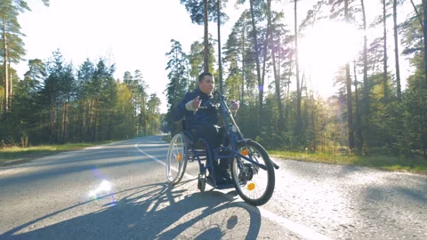 One man rides a special bicycle for disabled people. Video stock 89877578