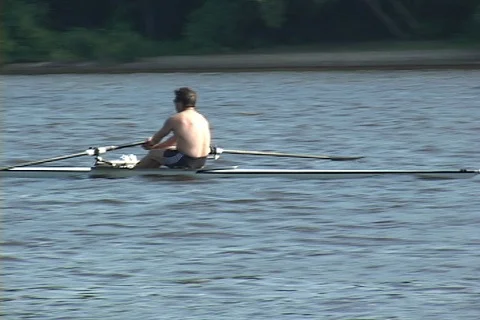 One man  rowing crew in training- narrow rowing shell Stock Footage 125498347