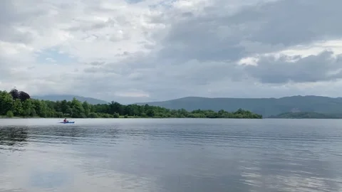 One man rowing on Kayak in open calm water Stock Footage 244584310