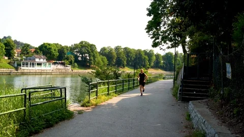 One man is running in the park, by the river Video stock 111877702