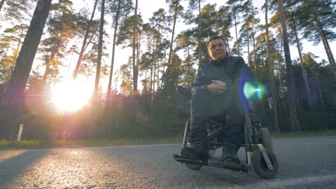 One man sits in a black wheelchair. Stock Footage