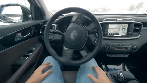 One man sits in a car while it is self-driving, close up. Stock Footage 100564846