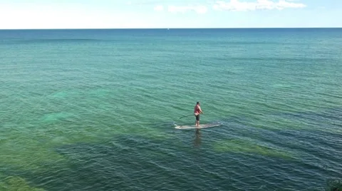 One man standing on paddle board Stock Footage 56842383