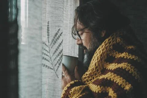 One man suffering cold temperature condition inside home for gas energy sav.. Stock Photos