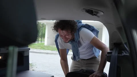 One man travel put stuff belongings to back of car prepare for travel 스톡 동영상 248168575