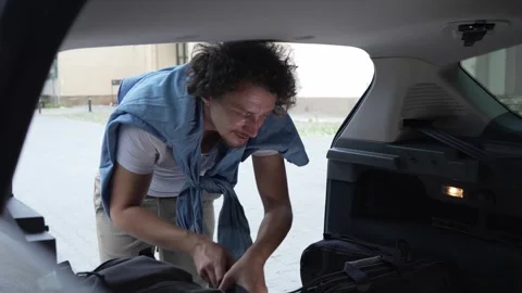 One man travel put stuff belongings to back of car prepare for travel Stock Footage 248168584