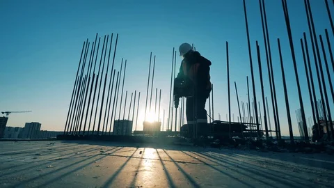One man uses a drill on a construction site. Stock Footage 127469546