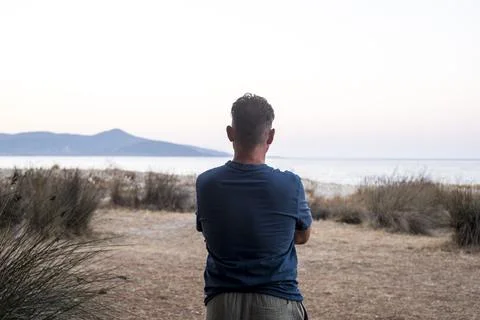 One man viewed from back in landscape contemplation. Tourist looking scenic.. Foto stock