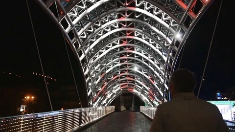 One man walk over the ulluminating lights bridge in slow motion Vidéo 82608790